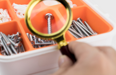 Magnifying the head of a screw nut nails boxの写真素材