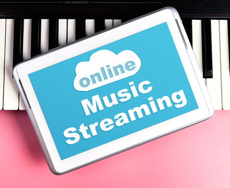 Online Music Streaming poster on tablet and keyboardの写真素材
