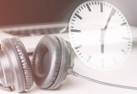 Studio time concept with computer studio and clock counting timeの写真素材