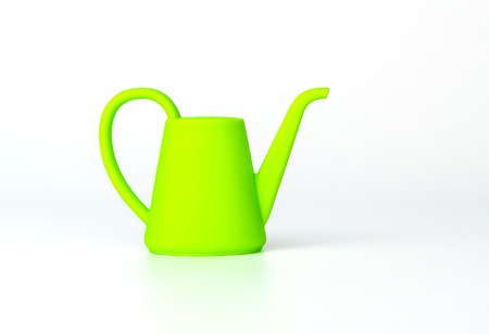 Green watering can toy isolated on whiteの写真素材