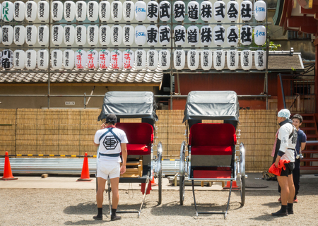 Tokyo, Japan - May 4, 2017: Japanese man in traditional clothes, pulling a rickshaw cartのeditorial素材