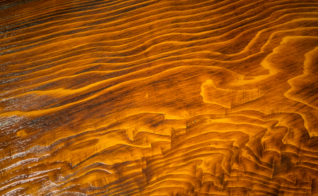 Dark brown shiny wooden surface for texture and backgroundの写真素材