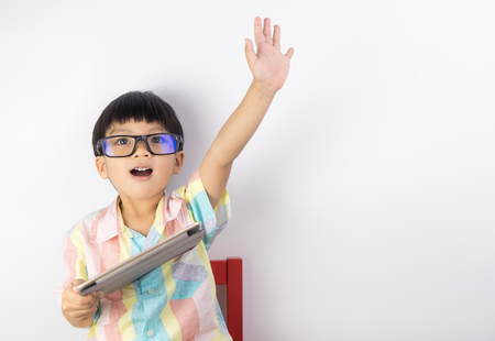 boy holding tablet raise his hand up for children right on internetの写真素材
