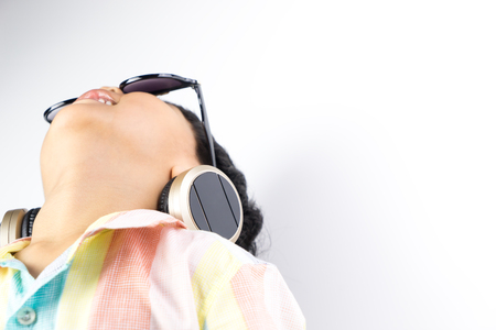 Boy is listening to music and look up to the sky isolatedの写真素材