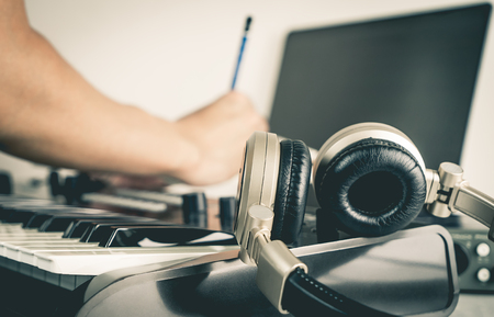 Musician is writing song in Home studio computerの写真素材