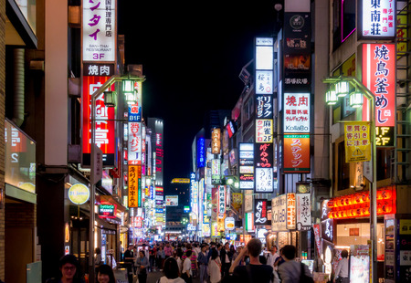 Tokyo, Japan - May 5, 2017:  Advertising signages lighten up at night in Shinjuku street.のeditorial素材
