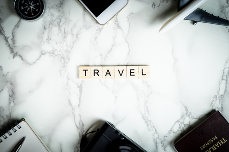 Travel text with accessories on marble surfaceの写真素材