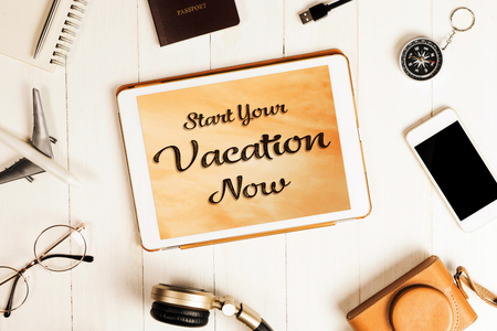 Classic Start your vacation now poster on tablet screenの写真素材