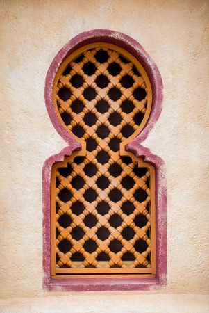 Wooden Arabian windows on orange plaster wallの写真素材