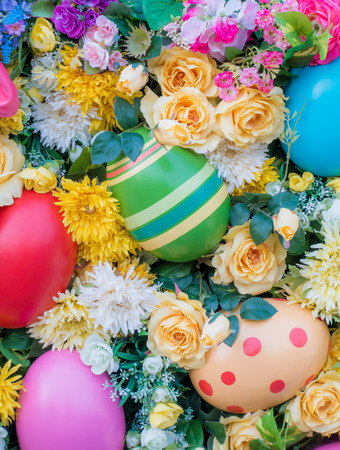 Easter eggs decoration surrounded by colorful flowerの写真素材