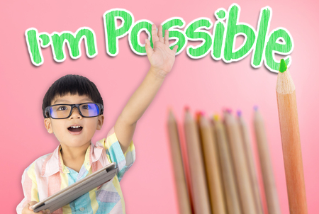 Boy raise his hand confidence that he is possible to do everythingの写真素材