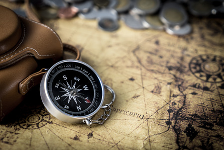 Compass and camera on vintage map copy spaceの写真素材