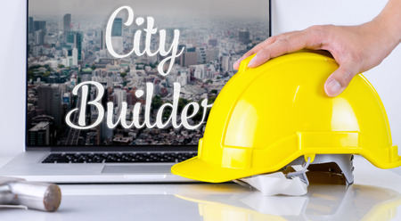 City builder is picking up safety helmet to workの写真素材