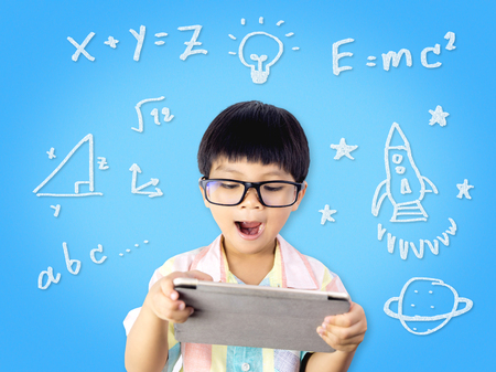 Nerdy Kid is getting Education from Internet tabletの写真素材