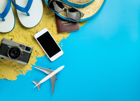 Beach Summer Vacation travel accessories and fashion on Sand and blue background.の写真素材
