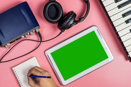 Songwriter musician is using tablet for Music producing.の写真素材
