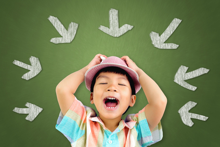 Little Asian boy with a Hat is singing song out loud.の写真素材