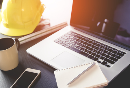 Engineer working desk with computer and notebookの写真素材