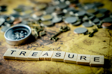 Vintage treasure hunting concept with coins and compassの写真素材
