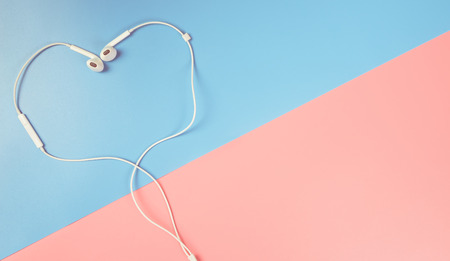 Heart shaped earphone on blue and pink copy spaceの写真素材