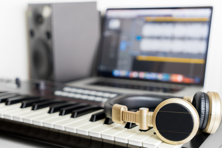 Home Music computer studio with golden headphoneの写真素材