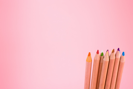 Bunch of color pencils on pink copy spaceの写真素材