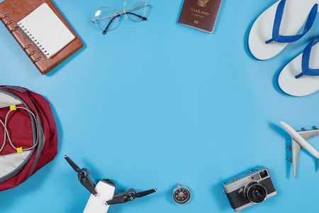 Travel gadgets and accessories on blue copy space in the middleの写真素材