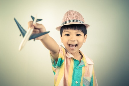 Asian boy is exciting to travel on Airplane toyの写真素材
