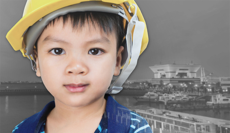 Kid want to be an engineer with port city backgroundの写真素材