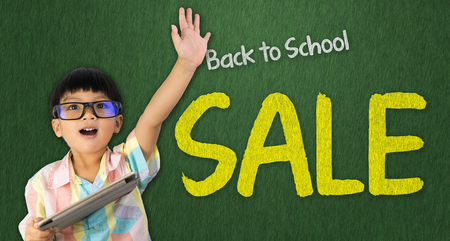 boy holding tablet raise his hand up for Back to School saleの写真素材