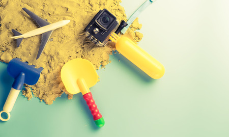 Summer beach travel toy on blue sand backgroundの写真素材