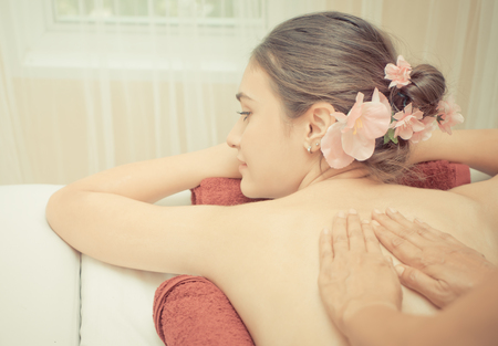 Thai Massage Therapist is rubbing oil on a woman's backの写真素材