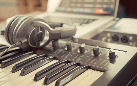 Home studio working desk with keyboard and headphoneの写真素材