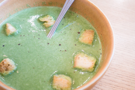Homemade broccoli soup with crispy bread in a bowlの写真素材