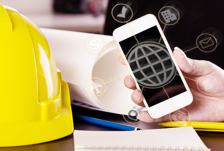 Engineer is using mobile technology for industry communicationの写真素材