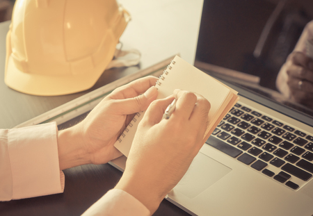Business man in construction industry is taking note in officeの写真素材
