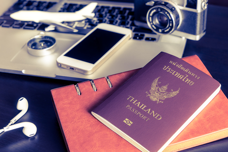 Thai passport with travel objects on office tableの写真素材