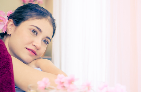 Women lying on spa bed with large copy spaceの写真素材