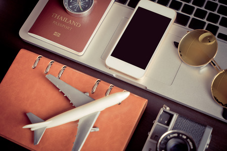 Blank empty phone screen mock up on travel blogger working deskの写真素材