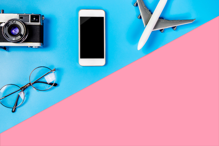 Smartphone with empty screen and travel object on blue and pink copy spaceの写真素材