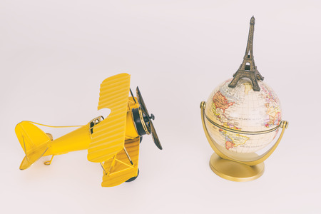 Vintage metal plane toy traveling the world to Parisの写真素材