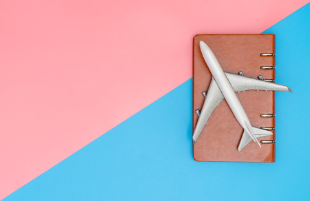 Toy plane with notebook for travel planning concept with copy spaceの写真素材