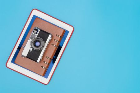Travel blogger reviewe equipment camera and notebook with blue copy spaceの写真素材