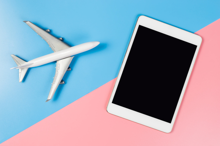Empty tablet screen with toy plane for travel website mock upの写真素材