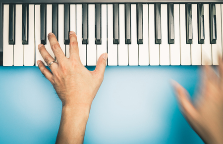 Fast hand Music keyboard player is playing on keyboard top viewの写真素材