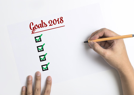 Hand writing down checklists for 2018 Goals on paper top view copy spaceの写真素材