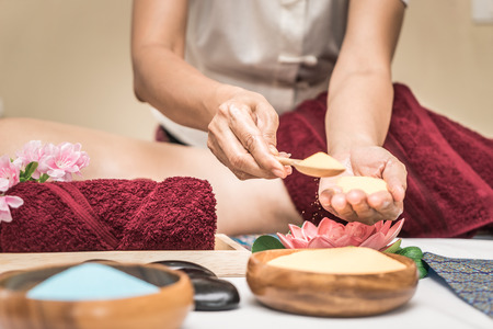 Spa Therapist is putting scrub on her handの写真素材