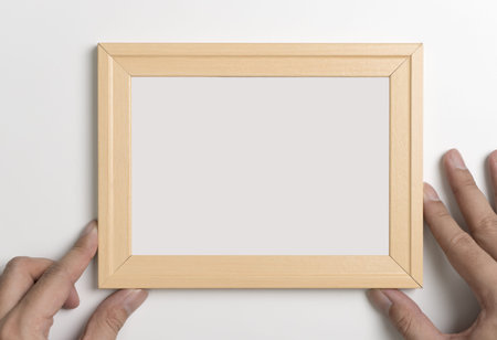 Hands holding Blank wooden photo frame for mock up