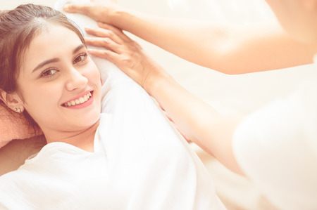 Happy woman is receiving massage treatment in Thai Spaの写真素材