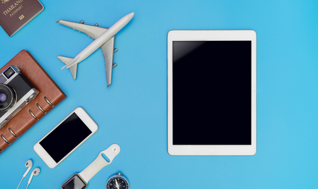 Empty mobile tablet screen for mock up in travel concept with travel gadget on blue backgroundの写真素材